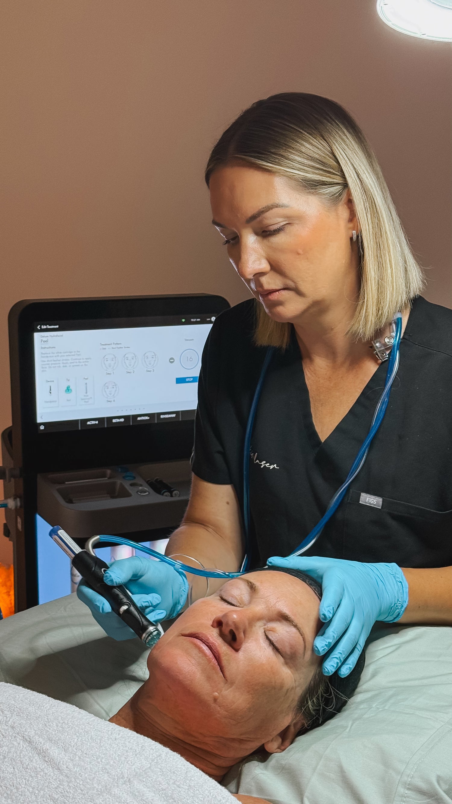 Skin therapist performing Hydrafacial Treatment